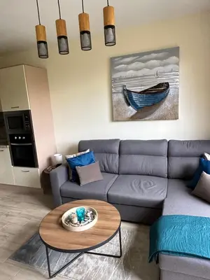 a living room with a couch and a table at Apartament CASCADAS FAMILY in Sunny Beach