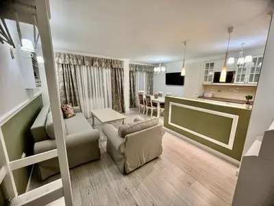a living room and kitchen with a couch and a table at Sea angel in Burgas City