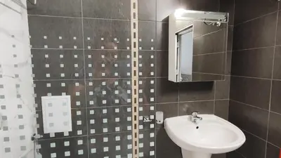 a bathroom with a sink and a toilet and a mirror at Sea angel in Burgas City