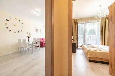 a bedroom with a bed and a dining room at Casa de la playa in Varna City