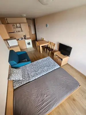 a small room with a bed and a dining room at VV Vigo Apartments in Nesebar