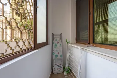 a window with a fence and a vase next to it at Peaceful Central Place - Vazov street in Varna City