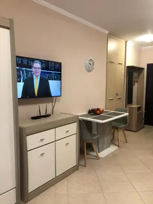 a room with a tv on a wall with a table at Private Studio Sunny Beach- Cascadas in Sunny Beach