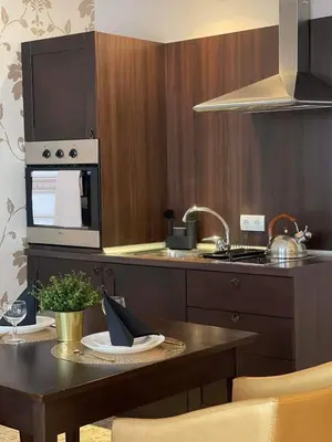 a kitchen with a table and a stove top oven at Royal Beach NICE VIEW in Sunny Beach