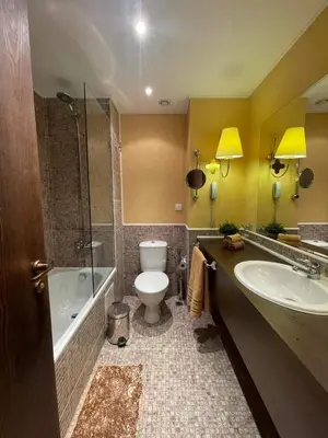 a bathroom with a toilet and a tub and a sink at Royal Beach NICE VIEW in Sunny Beach