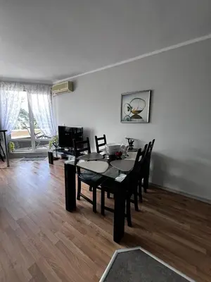 a dining table and chairs in a living room at Apartment for rent in Sunny Beach/ Nessebar in Nesebar