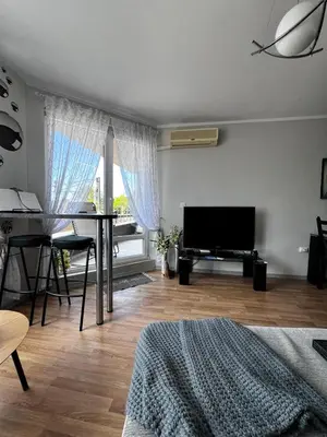 a living room with a table and a television at Apartment for rent in Sunny Beach/ Nessebar in Nesebar