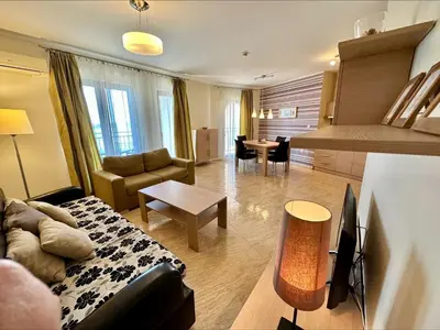 a living room with a couch and a table at Sea View Apartments - Aheloy in Ravda