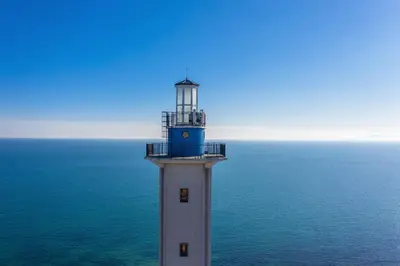 a lighthouse sitting in the middle of the ocean at Sea View Apartments - Aheloy in Ravda