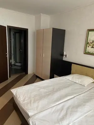 a bedroom with a large white bed and a bathroom at SEAVIEW Heaven Sunny Beach in Sunny Beach