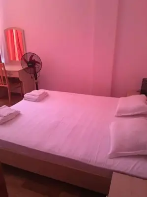 a bedroom with a large bed with pink walls at 3 Bedroom Apt with Pool Views at Arcadia Complex in Sunny Beach