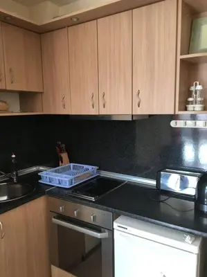 a kitchen with black counter tops and wooden cabinets at 3 Bedroom Apt with Pool Views at Arcadia Complex in Sunny Beach