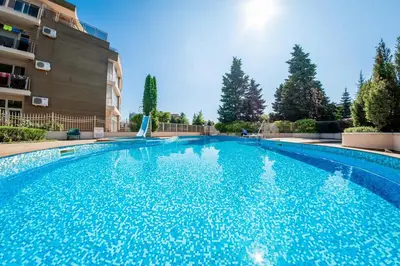 a large swimming pool in front of a building at Central, 3 Bedroom Apartment at Golden Fort Complex in Sunny Beach
