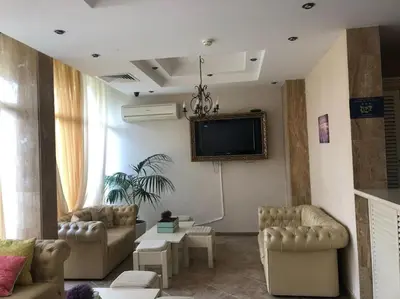 a living room with couches and a flat screen tv at Spacious, 1 Bed Apt, Dawn Park in Sunny Beach