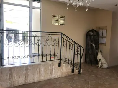 a dog sitting on the floor next to a staircase at Spacious, 1 Bed Apt, Dawn Park in Sunny Beach