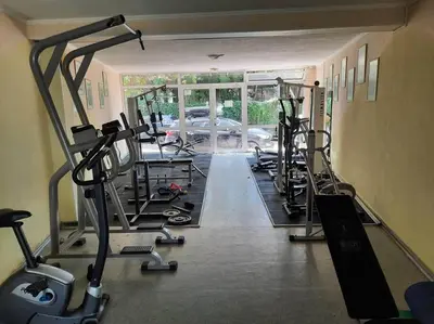 a gym with several tread machines in a room at Central, 1 Bed Apt, 3* Yassen in Sunny Beach