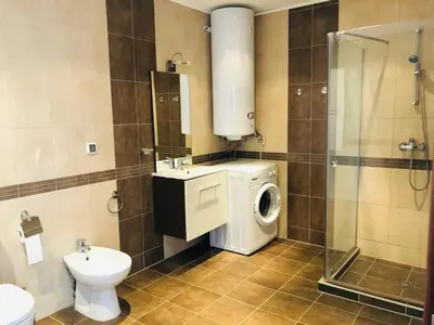 a bathroom with a washing machine and a toilet at Mia Cassa in Sveti Vlas