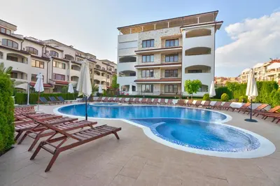 a swimming pool with lounge chairs and a building at Mia Cassa in Sveti Vlas
