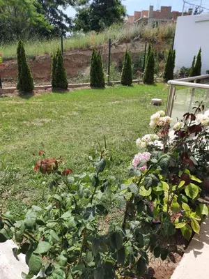 a garden with flowers and plants in a yard at Прекрасный апартамент с видом на море и бассейном in Byala