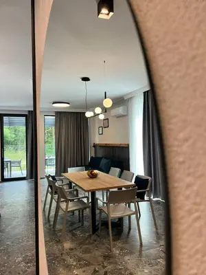 a dining room with a table and chairs at Villas Park Lozenets in Lozenets