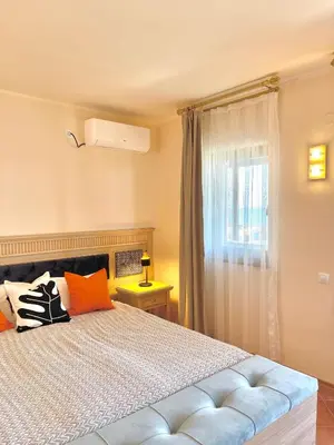 a bedroom with a bed and a window at SH Holidays & Health Beach-Apartments in Sozopol