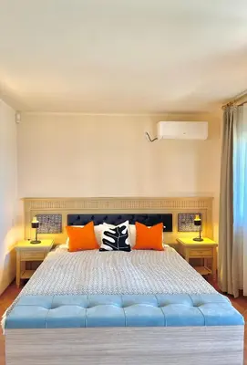 a bedroom with a large blue bed with orange pillows at SH Holidays & Health Beach-Apartments in Sozopol
