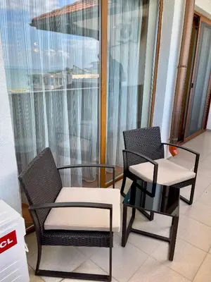 two chairs and a table in a room at SH Holidays & Health Beach-Apartments in Sozopol