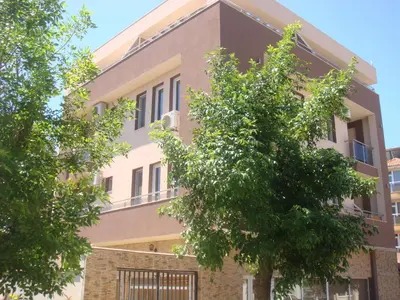 a building with trees in front of it at Ivatea Family Hotel in Ravda