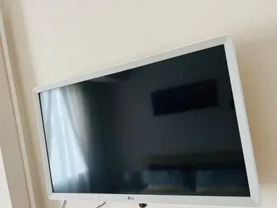 a flat screen tv sitting on a wall at Апартамент Sunny home in Chernomorets