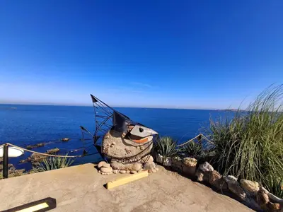 a statue of a turtle with an umbrella on its head at Апартамент Sunny home in Chernomorets