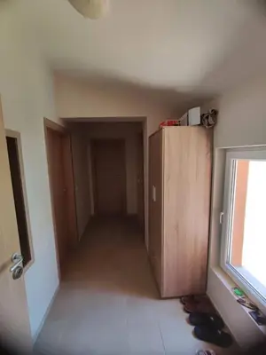 a room with a hallway with a door and some shoes at The View Apartment in Sozopol