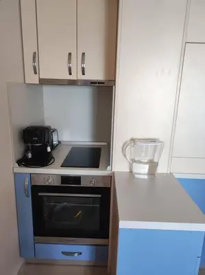 a small kitchen with a stove and a microwave at The View Apartment in Sozopol
