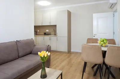 a living room with a couch and a table at Bellicity Apart Complex in Ravda