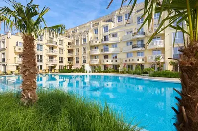 a large swimming pool in front of a building at Bellicity Apart Complex in Ravda
