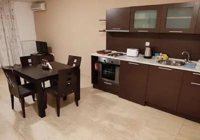 a kitchen with a table and a kitchen with a sink at Kims One-bed Apart for rent at Sunny Beach Resort in Sunny Beach