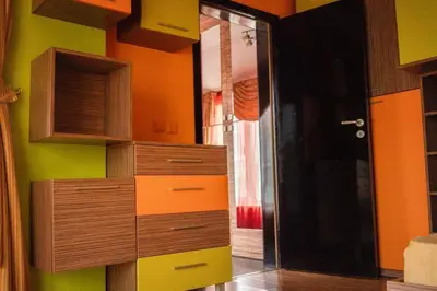 a kitchen with a bunch of drawers and a door at Aпартамент в близост до морето и центъра in Burgas City