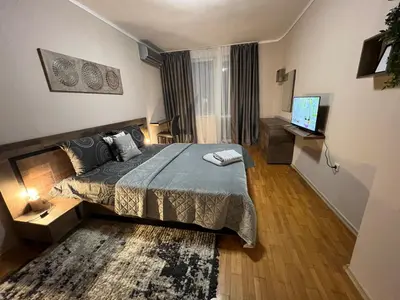 a bedroom with a bed and a television in it at Център Варна апартамент с паркинг за нормална до средно голяма кола in Varna City