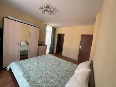 a bedroom with a bed and a dresser and a mirror at Elit 4 Apartments in Sunny Beach