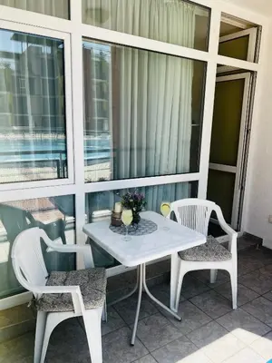 a white table and chairs on a balcony at Elit 4 Apartments in Sunny Beach