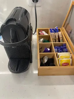 a blender sitting on a counter next to a wooden drawer at Nova City Apartments in Varna City