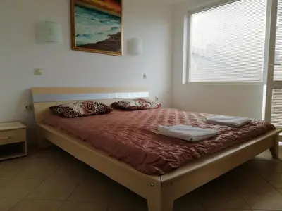 a bed in a bedroom with two pillows on it at Apartments Bravo 1-Vichevi in Sunny Beach