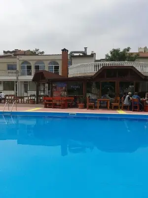 a large blue swimming pool in front of a building at Apartments Bravo 1-Vichevi in Sunny Beach