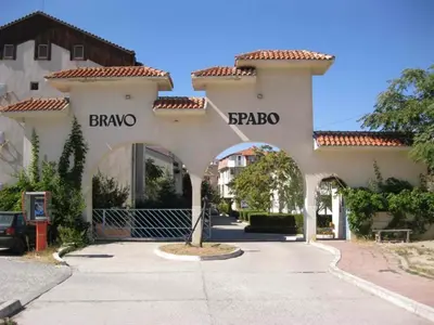 a building with an archway in front of a street at Apartments Bravo 1-Vichevi in Sunny Beach