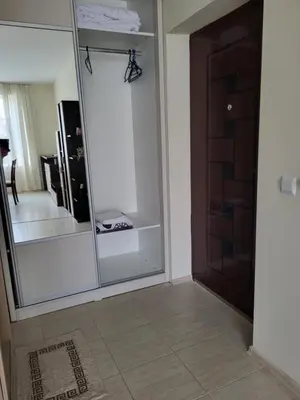a large mirror in a room with a door at Комплекс Конти in Ravda