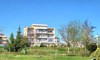 a large building with benches in front of it at Комплекс Конти in Ravda