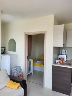 a small room with a bed and a bedroom at Комплекс Конти in Ravda