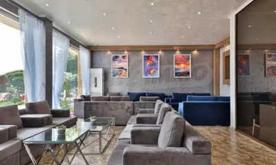 a large living room with couches and a table at Студио Симона 5 първа линия море in Lozenets