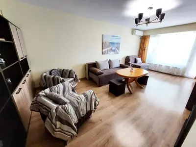 a living room with a couch and a table at Апартамент за гости , жк. Зорница, бл.36 in Burgas City