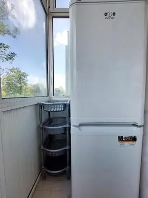 a white refrigerator in a room with a window at Апартамент за гости , жк. Зорница, бл.36 in Burgas City