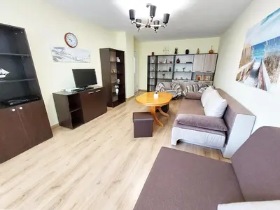 a living room with a couch and a table at Апартамент за гости , жк. Зорница, бл.36 in Burgas City